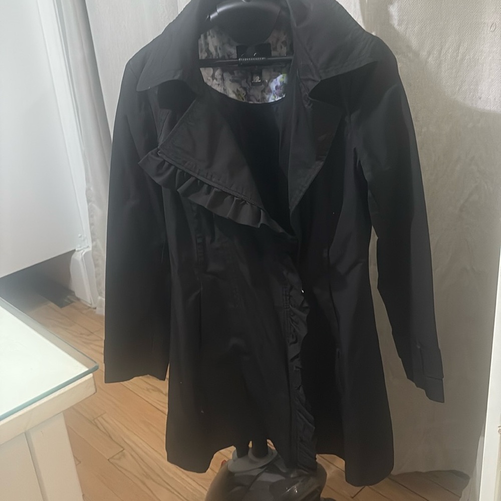 Pretty black zipper up trench coat with ruffle.  Jessica Simpson size medium.